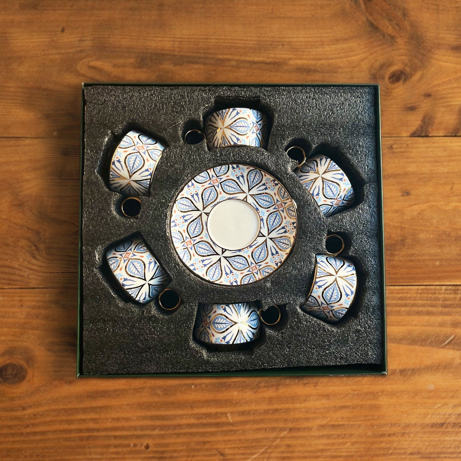 Decorative stone set in a black box on a wooden surface