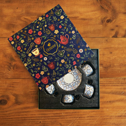 Decorative tea set with floral patterned box on a wooden surface